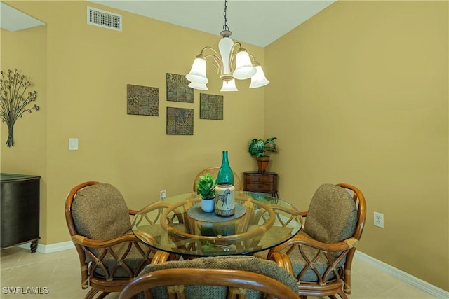 dining space with light tile patterned floors and a chandelier