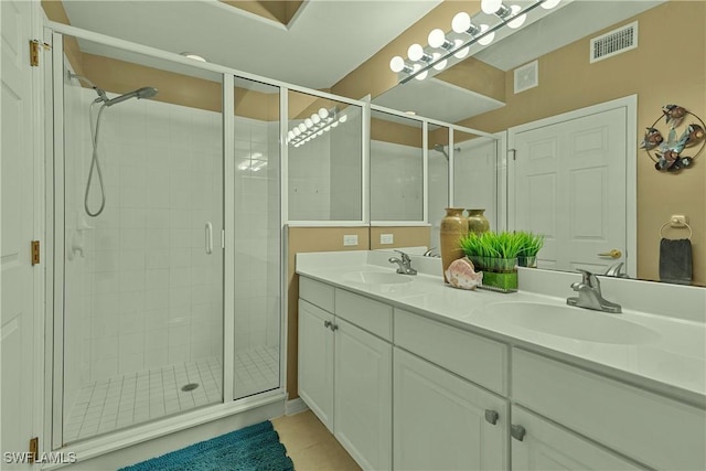 bathroom with tile patterned flooring, vanity, and an enclosed shower