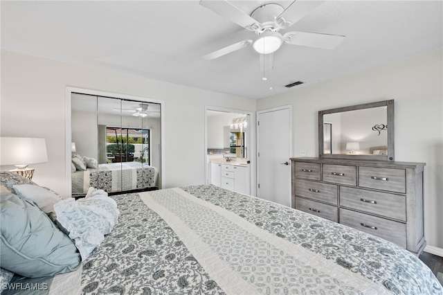 bedroom with ceiling fan, wood-type flooring, and connected bathroom