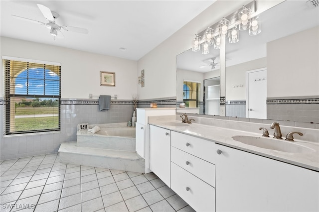 bathroom with vanity, a bath, tile patterned floors, and ceiling fan