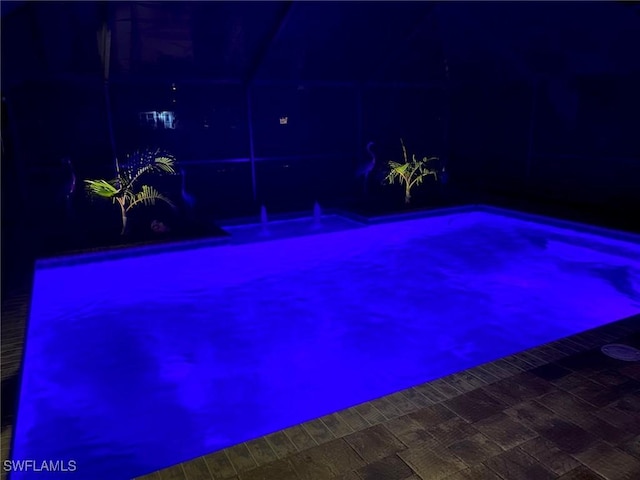 view of pool at night