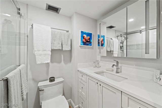 bathroom with vanity, toilet, and an enclosed shower