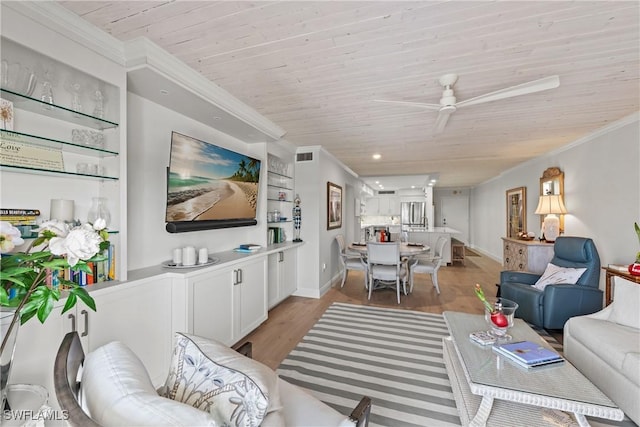 living room with built in features, ceiling fan, crown molding, and wooden ceiling