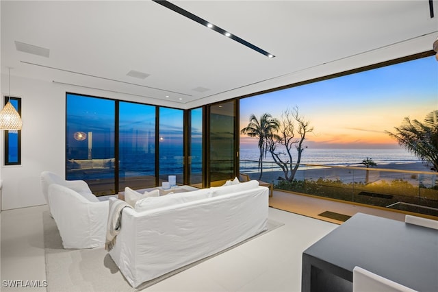 living room featuring a water view and a wall of windows