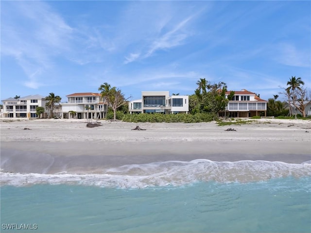 exterior space with a water view and a view of the beach