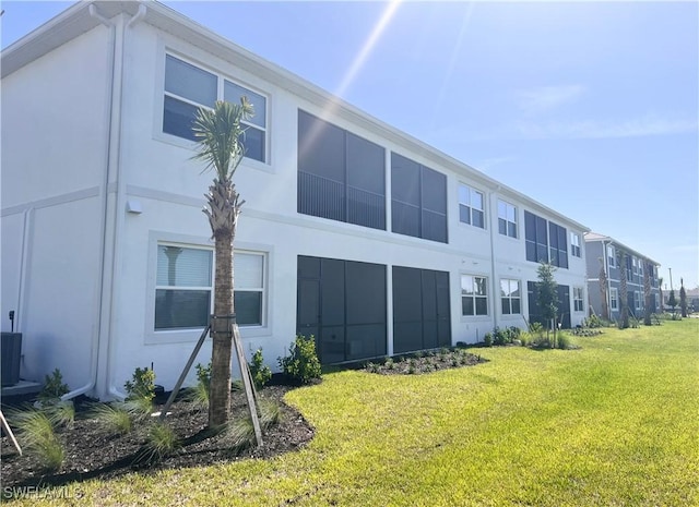 rear view of property featuring a yard