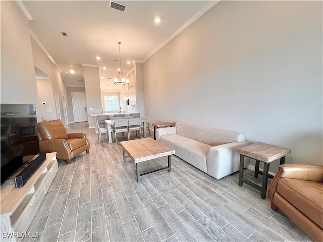 living room featuring crown molding and a notable chandelier