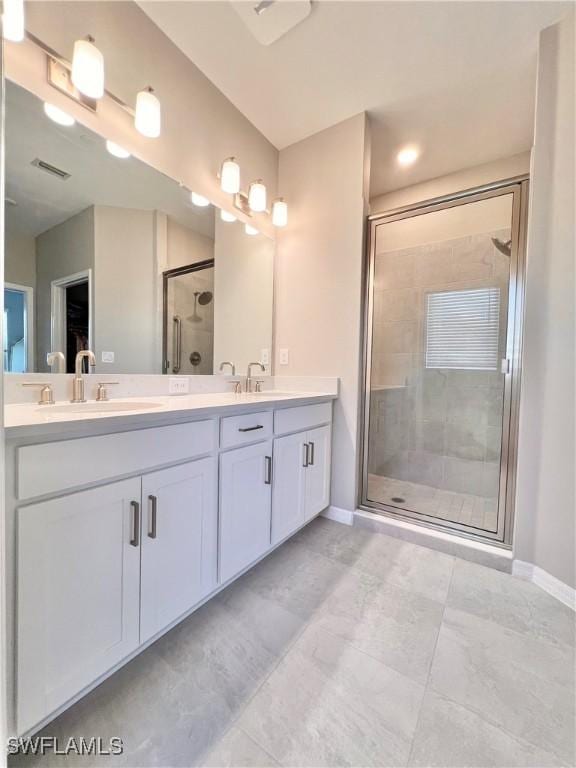 bathroom featuring vanity and an enclosed shower