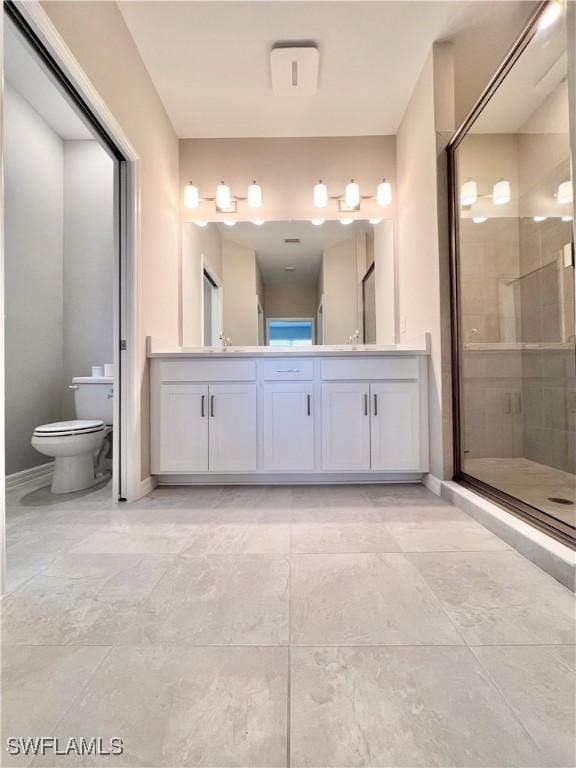 bathroom with walk in shower, vanity, and toilet