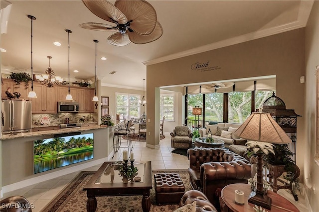 tiled living room with ceiling fan with notable chandelier, crown molding, and a water view