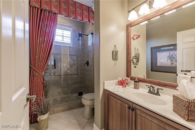 bathroom with vanity, a shower with shower door, tile patterned flooring, and toilet