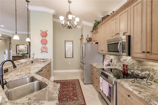 kitchen with light stone counters, sink, pendant lighting, and stainless steel appliances