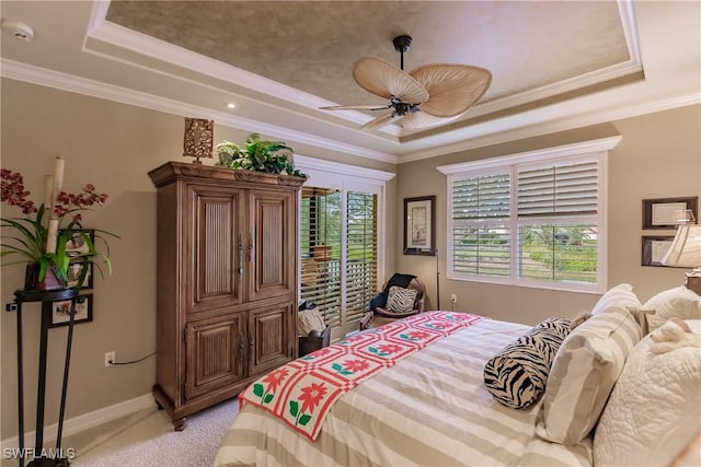 bedroom with light carpet, multiple windows, and a tray ceiling