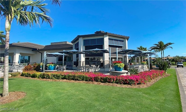 back of property featuring a patio and a yard