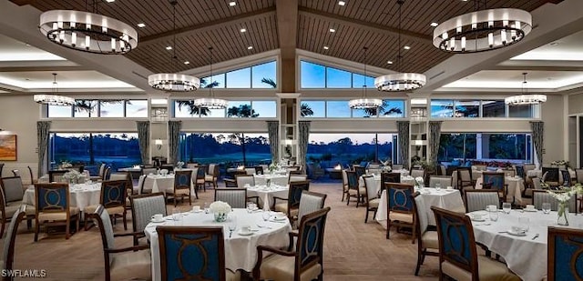 dining space with an inviting chandelier, beamed ceiling, wood ceiling, and high vaulted ceiling