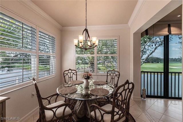 tiled dining room featuring a wealth of natural light, baseboards, a chandelier, and ornamental molding