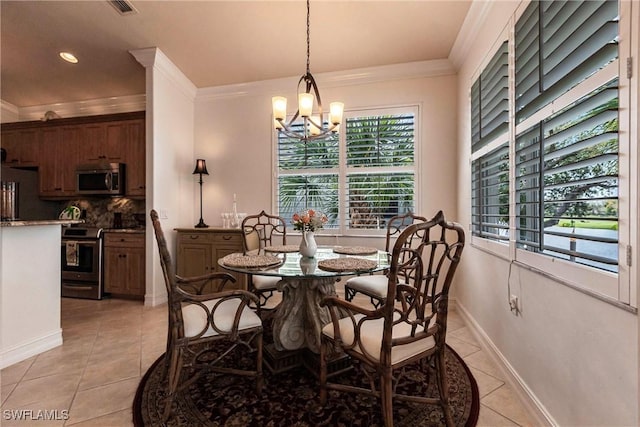 dining area featuring ornamental molding, light tile patterned flooring, baseboards, and a chandelier