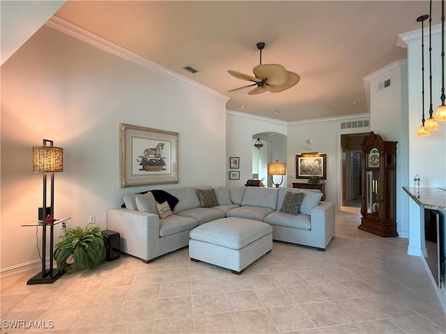 living room with a ceiling fan, visible vents, arched walkways, and ornamental molding