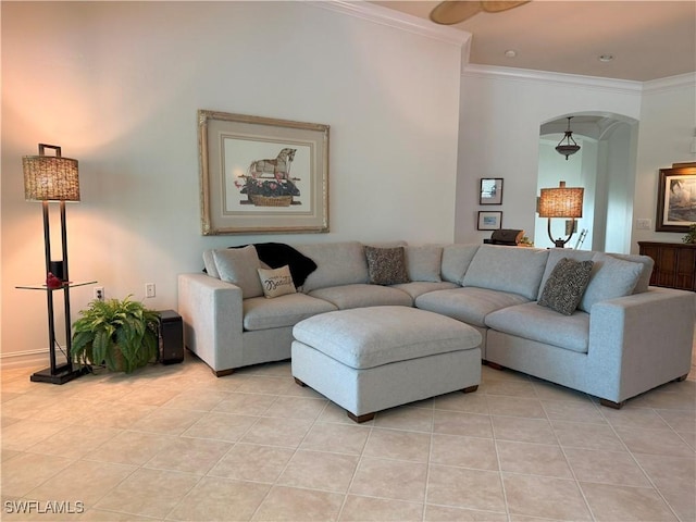 living room with light tile patterned floors, arched walkways, and crown molding