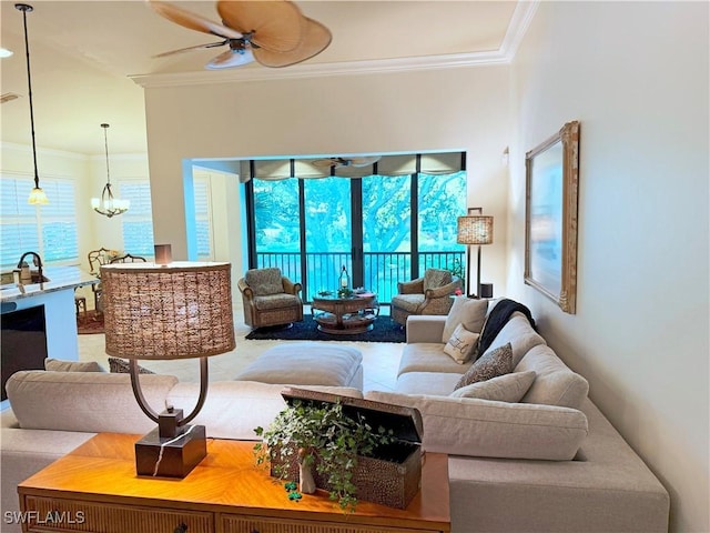 living room featuring ornamental molding and ceiling fan with notable chandelier