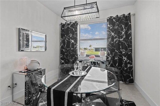 dining space with concrete floors and a chandelier