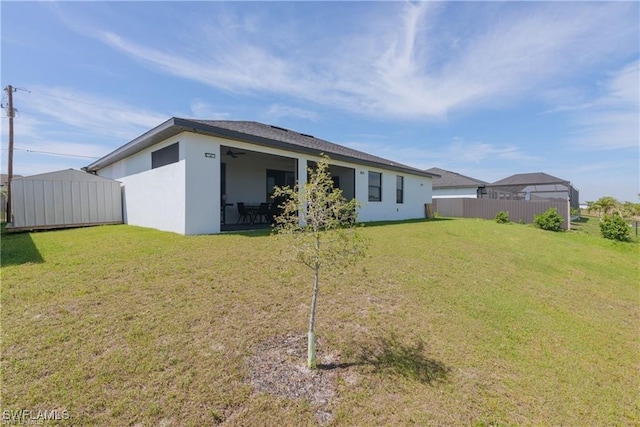 rear view of property with a lawn