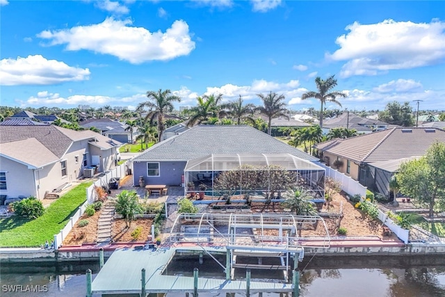 view of dock with a lanai and a water view