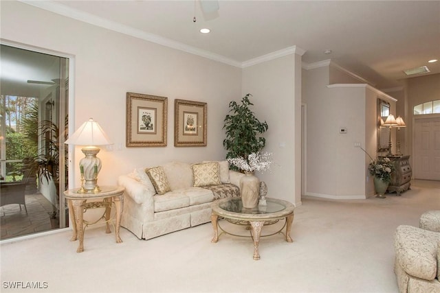 carpeted living room with crown molding and ceiling fan