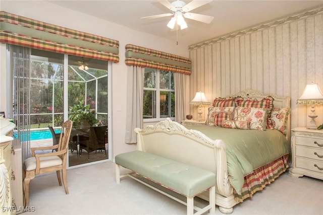 bedroom featuring access to exterior, light colored carpet, and ceiling fan