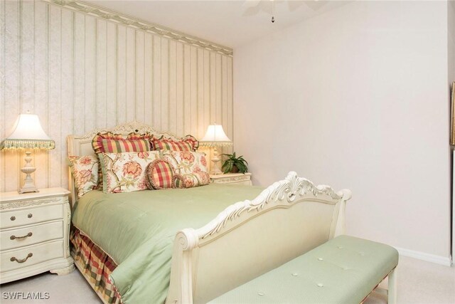 bedroom featuring light colored carpet and ceiling fan