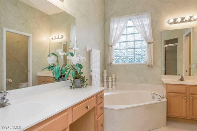 full bathroom featuring tile patterned floors, vanity, toilet, and separate shower and tub