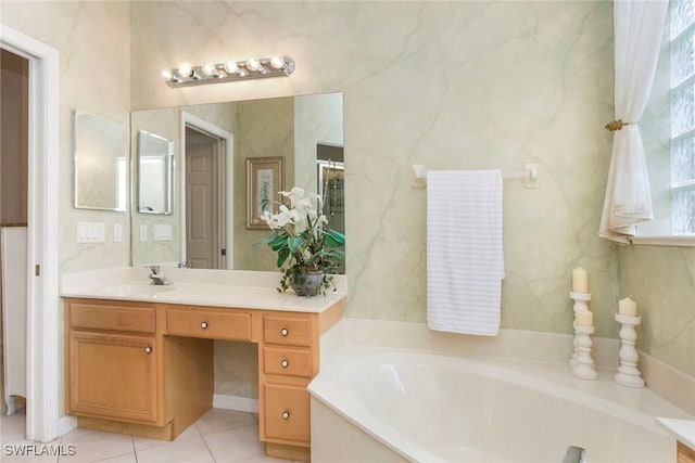 bathroom featuring vanity, a bath, and tile patterned floors