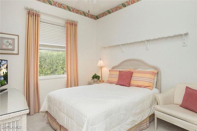 bedroom with ceiling fan and light colored carpet