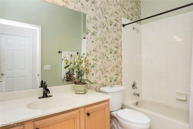 full bathroom featuring vanity, toilet, and tiled shower / bath