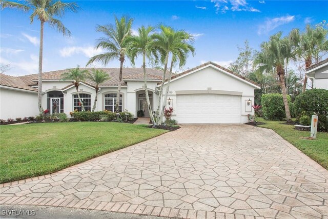 view of front of home featuring a garage and a front yard