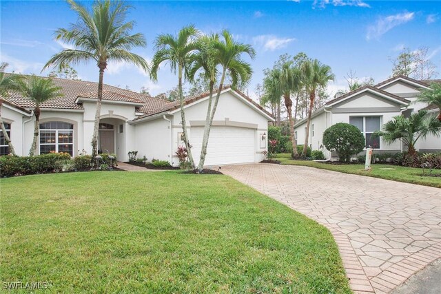 view of front of property with a garage and a front lawn