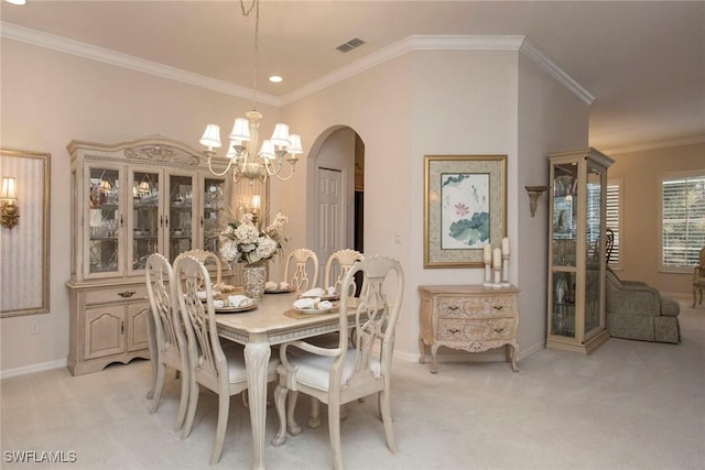 carpeted dining area with crown molding and an inviting chandelier