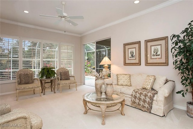 carpeted living room with crown molding and ceiling fan