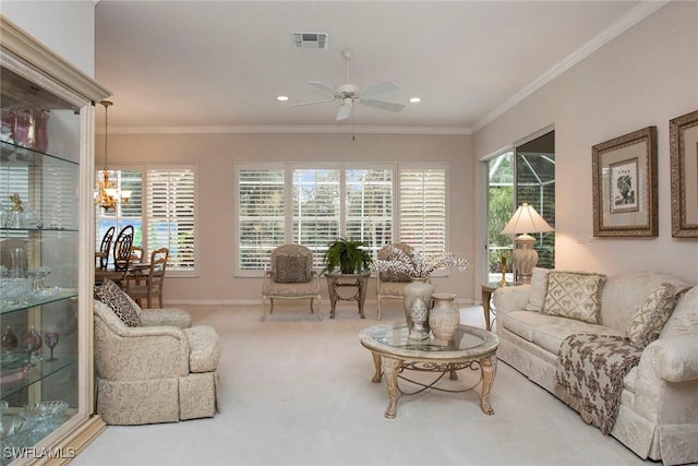 carpeted living room with crown molding and ceiling fan with notable chandelier