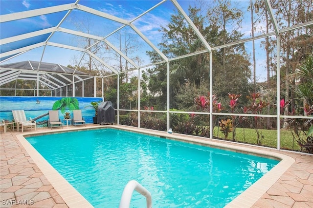 view of swimming pool featuring a grill, glass enclosure, and a patio area