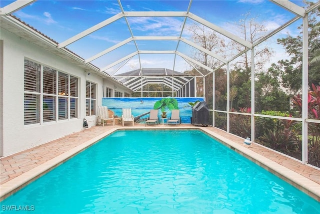 view of pool featuring glass enclosure