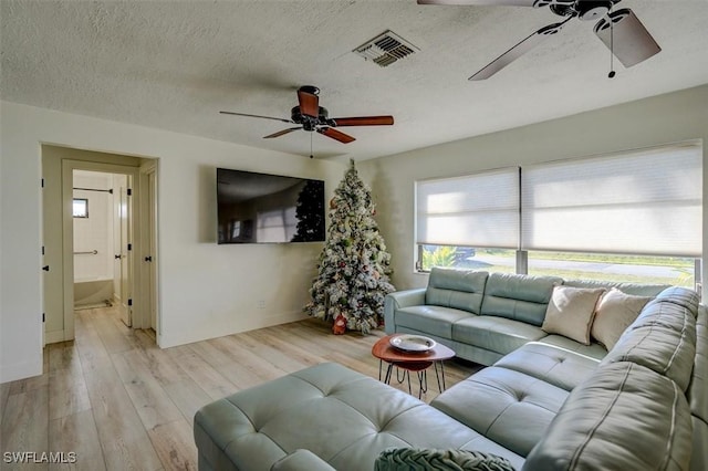 living room with light hardwood / wood-style floors and a textured ceiling