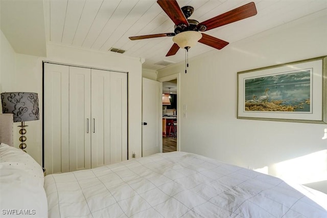 unfurnished bedroom featuring ceiling fan, wooden ceiling, and a closet