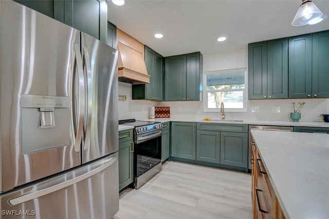 kitchen featuring pendant lighting, green cabinets, sink, and stainless steel appliances