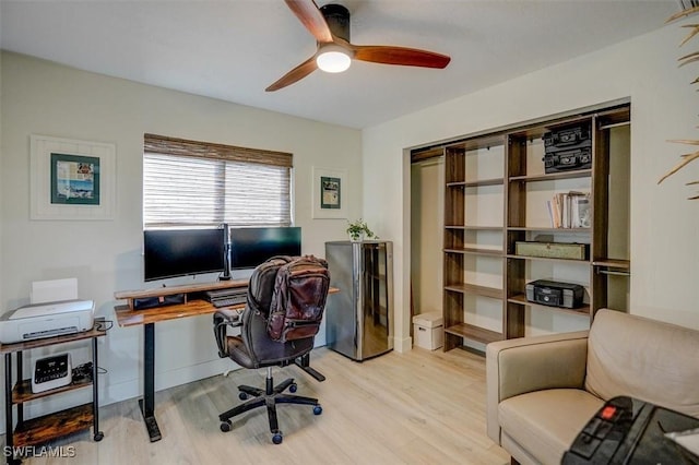 office space with light hardwood / wood-style flooring and ceiling fan