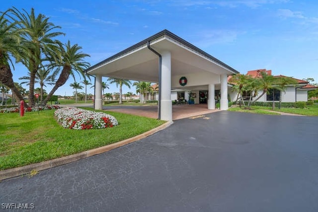 exterior space with a yard and aphalt driveway