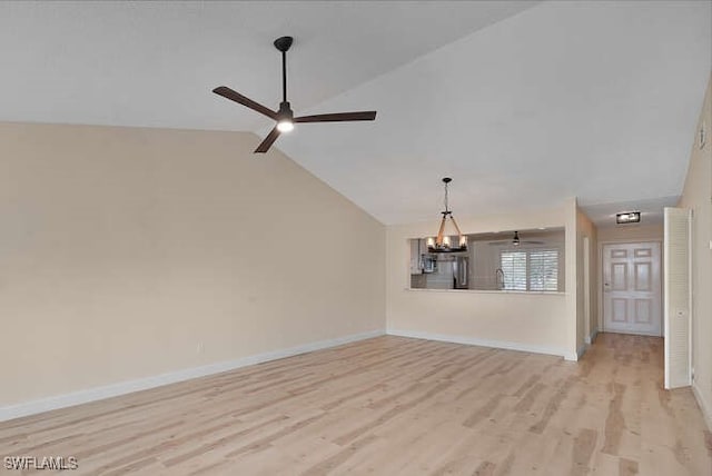 unfurnished living room featuring lofted ceiling, light wood finished floors, baseboards, and ceiling fan with notable chandelier