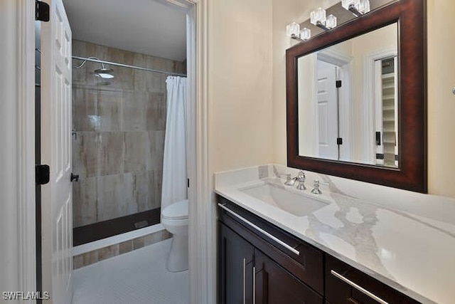 full bathroom with toilet, a shower stall, and vanity