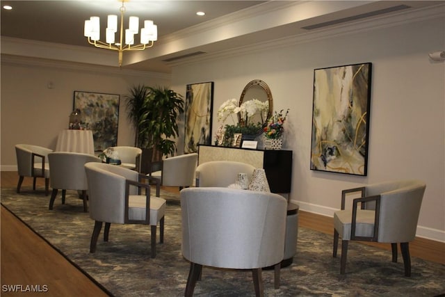 sitting room featuring crown molding, dark wood finished floors, and an inviting chandelier