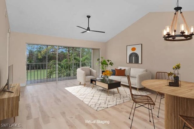 living room with high vaulted ceiling, light wood-type flooring, and ceiling fan with notable chandelier